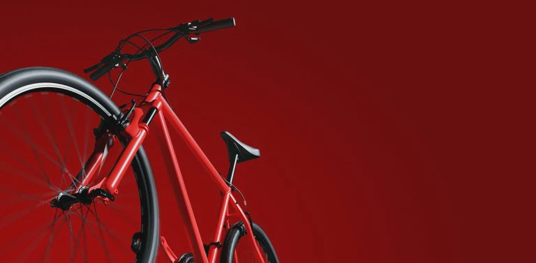 czerwony rower na&nbsp;czerwonym tle